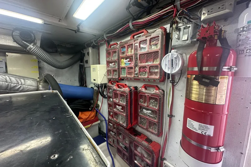 Patrona Yacht Photos Pics Engine room of 2000 Mikelson 61 Sportfisher with organized tools and fire extinguisher.