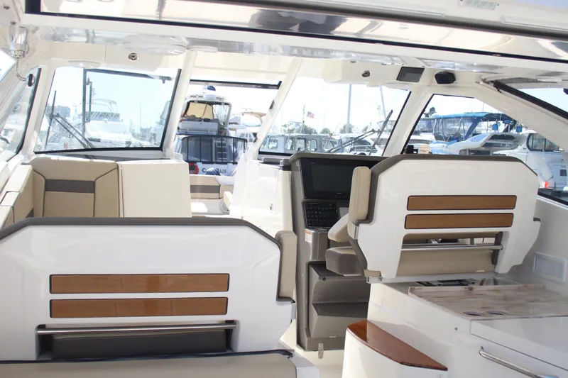 Flawless Seas Yacht Photos Pics 2019 Pursuit DC 365 Dual Console interior with modern seating and navigation area.