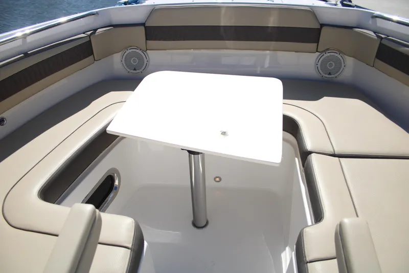 Flawless Seas Yacht Photos Pics 2019 Pursuit DC 365 Dual Console boat interior with table and seating.