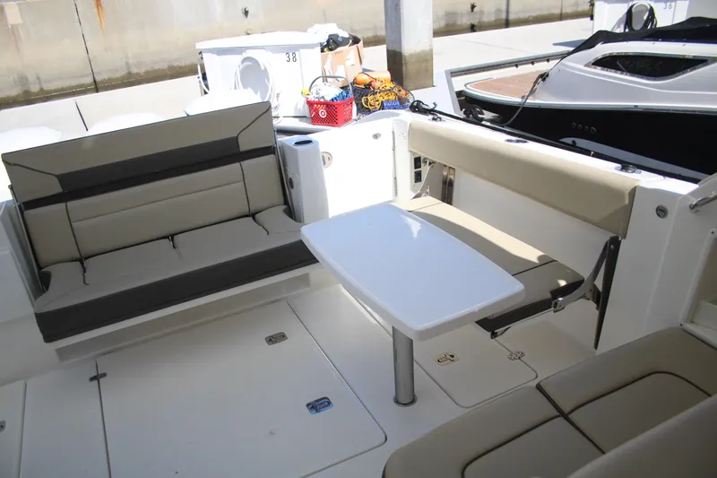 Flawless Seas Yacht Photos Pics 2019 Pursuit DC 365 Dual Console boat interior with seating and table.