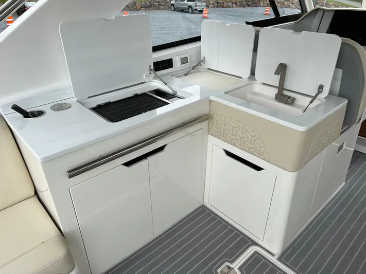  Yacht Photos Pics 2022 Regal LS36 boat kitchen area with sink and grill.