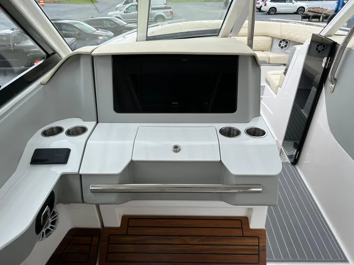  Yacht Photos Pics 2022 Regal LS36 boat interior with sleek dashboard and cup holders.