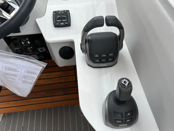 Yacht Photos Pics 2022 Regal LS36 boat controls with joystick and throttle on white console.