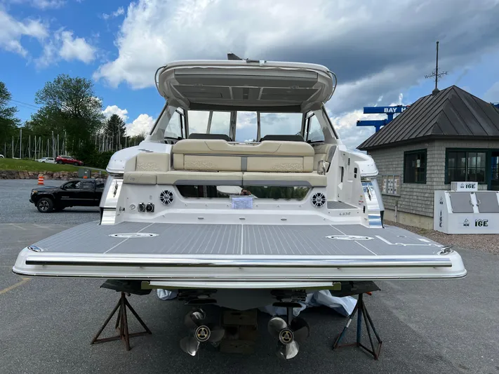  Yacht Photos Pics 2022 Regal LS36 boat with spacious deck and seating, parked outdoors.