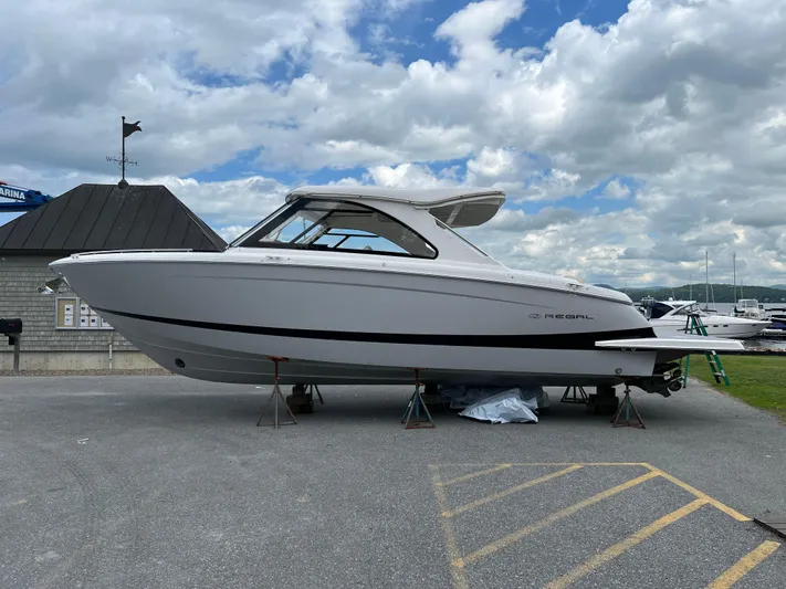  Yacht Photos Pics 2022 Regal LS36 boat on display at marina under cloudy sky.