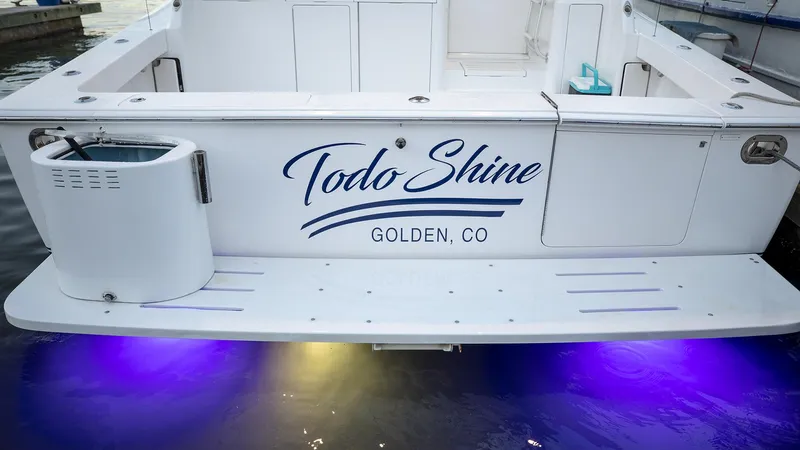 Todo Shine Yacht Photos Pics Stern of 2007 Viking 45 Convertible boat with "Todo Shine" name, purple underwater lights.