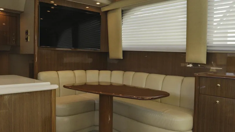 Todo Shine Yacht Photos Pics Luxurious interior of a 2007 Viking 45 Convertible yacht with leather seating and wood finishes.