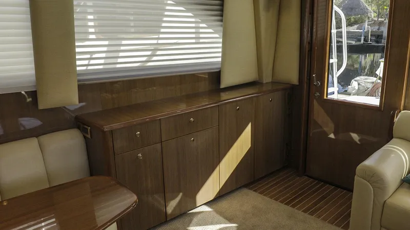 Todo Shine Yacht Photos Pics Interior of 2007 Viking 45 Convertible yacht with wooden cabinetry and seating.