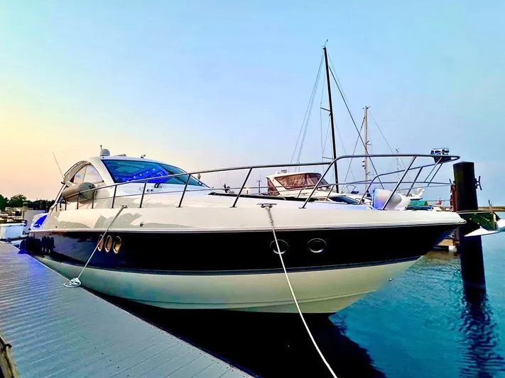  Yacht Photos Pics 2014 Cruisers Yachts 540 SC docked at sunset, showcasing sleek design and luxury features.