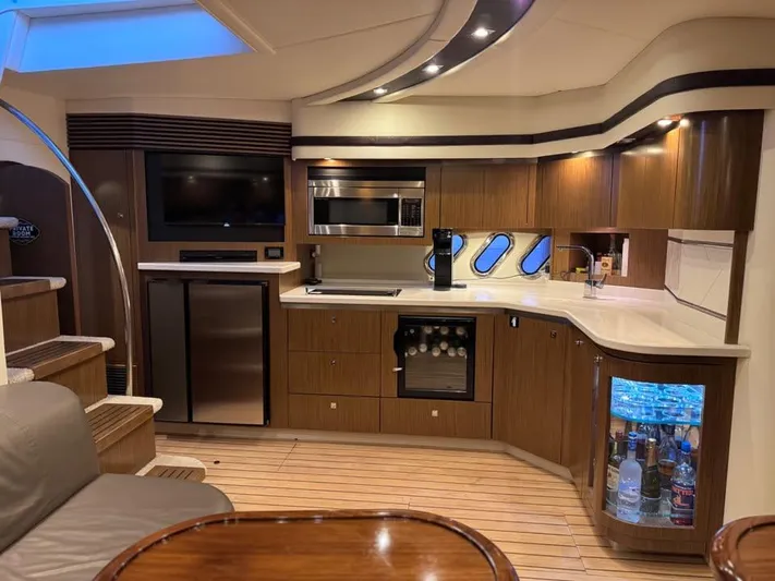  Yacht Photos Pics Luxurious 2014 Cruisers Yachts 540 SC interior with modern kitchen and elegant wood finishes.