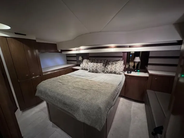  Yacht Photos Pics Luxurious bedroom interior of 2014 Cruisers Yachts 540 SC with elegant bedding and wood cabinetry.
