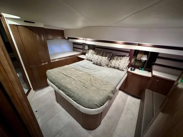 Yacht Photos Pics Luxurious bedroom interior of 2014 Cruisers Yachts 540 SC with elegant wood finishes.