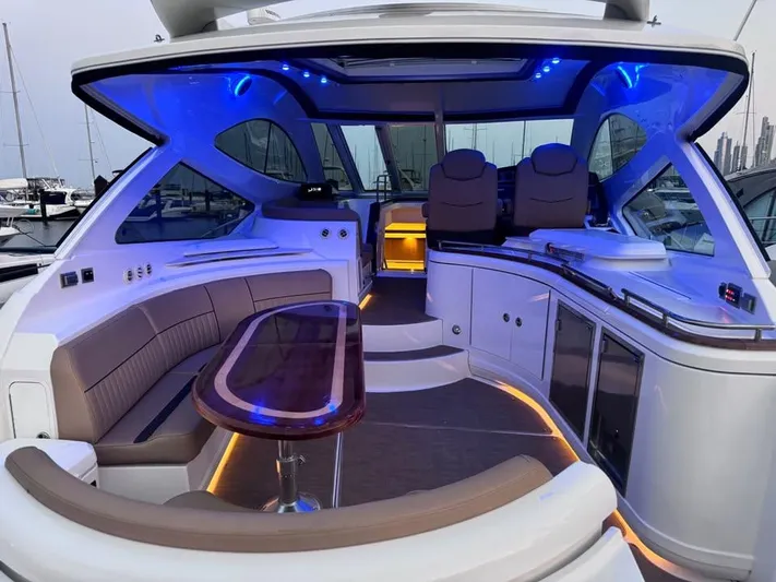  Yacht Photos Pics Luxurious 2014 Cruisers Yachts 540 SC interior with ambient blue lighting and elegant seating.