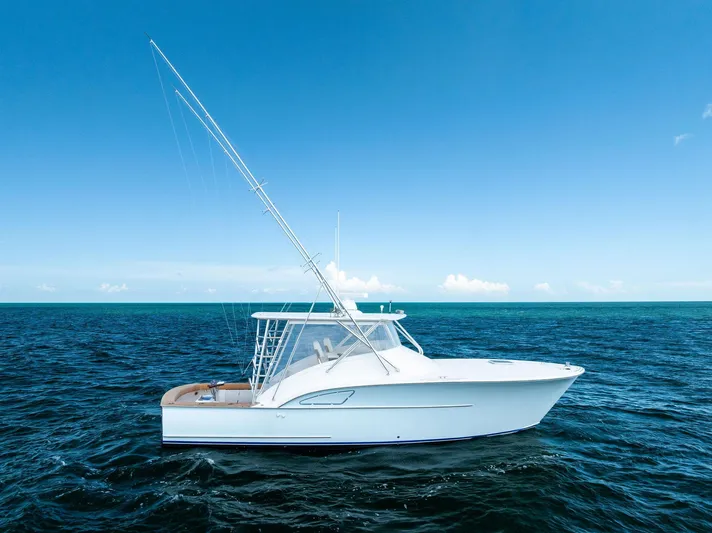 Let's Go Yacht Photos Pics 2018 Custom Carolina 35 Express boat on open ocean under clear blue sky.
