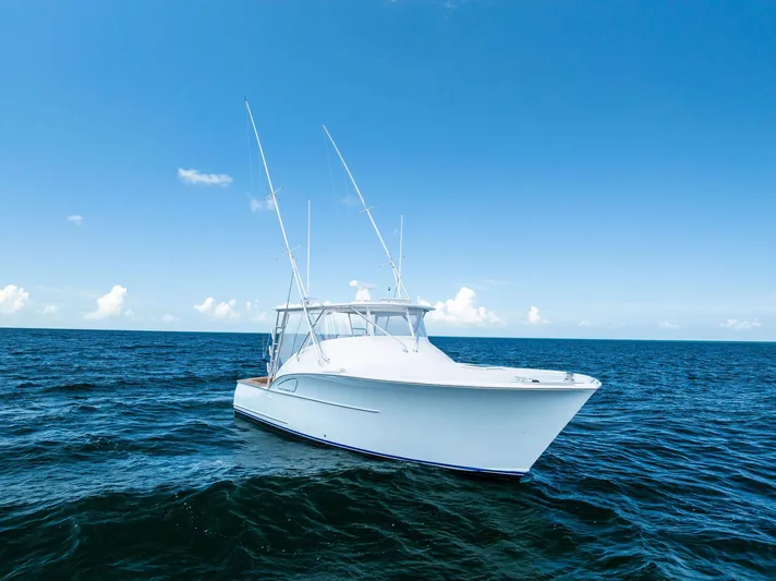 Let's Go Yacht Photos Pics 2018 Custom Carolina 35 Express boat on open sea under clear blue sky.