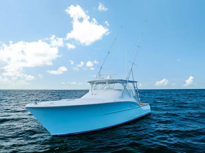 Let's Go Yacht Photos Pics 2018 Custom Carolina 35 Express boat on open sea under clear blue sky.