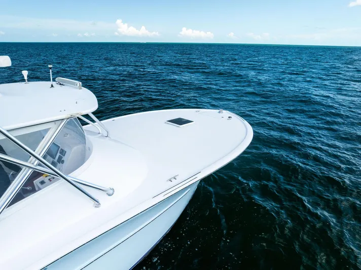 Let's Go Yacht Photos Pics 2018 Custom Carolina 35 Express boat on open ocean under clear blue sky.