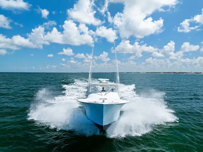 Let's Go Yacht Photos Pics 2018 Custom Carolina 35 Express cruising on open water under a clear blue sky.