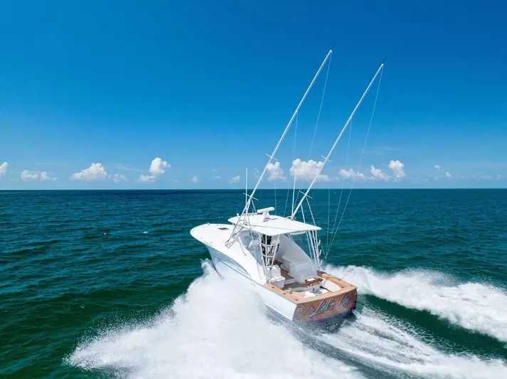 Let's Go Yacht Photos Pics 2018 Custom Carolina 35 Express yacht cruising on open ocean under clear blue sky.