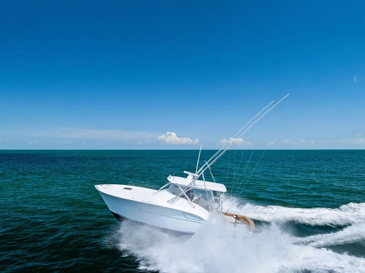 Let's Go Yacht Photos Pics 2018 Custom Carolina 35 Express cruising on open ocean under clear blue sky.