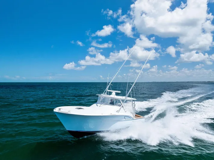 Let's Go Yacht Photos Pics 2018 Custom Carolina 35 Express boat cruising on open ocean under clear blue sky.