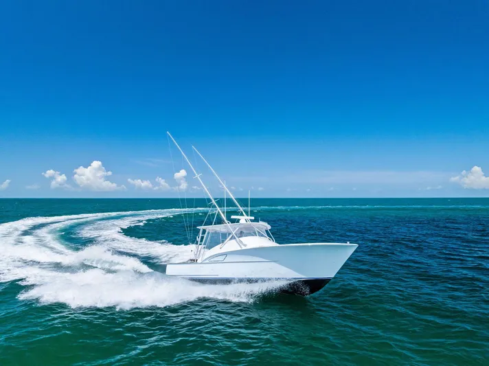 Let's Go Yacht Photos Pics 2018 Custom Carolina 35 Express cruising on open ocean under clear blue sky.
