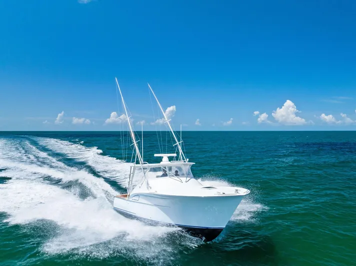 Let's Go Yacht Photos Pics 2018 Custom Carolina 35 Express boat cruising on open ocean under clear blue sky.