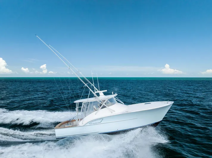Let's Go Yacht Photos Pics 2018 Custom Carolina 35 Express yacht cruising on open ocean under clear blue sky.