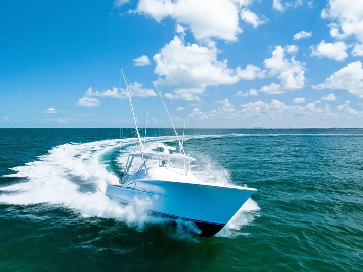 Let's Go Yacht Photos Pics 2018 Custom Carolina 35 Express cruising on open ocean under clear blue sky.