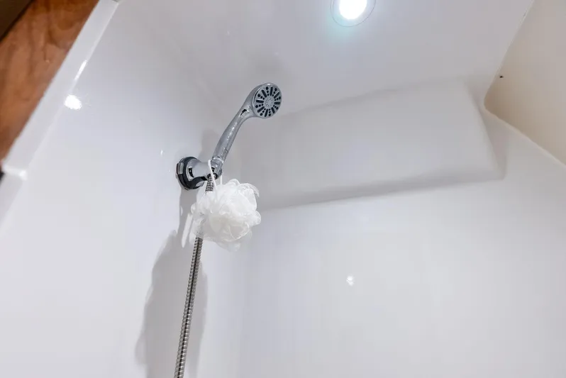Let's Go Yacht Photos Pics Shower area in 2018 Custom Carolina 35 Express boat with handheld showerhead and loofah.