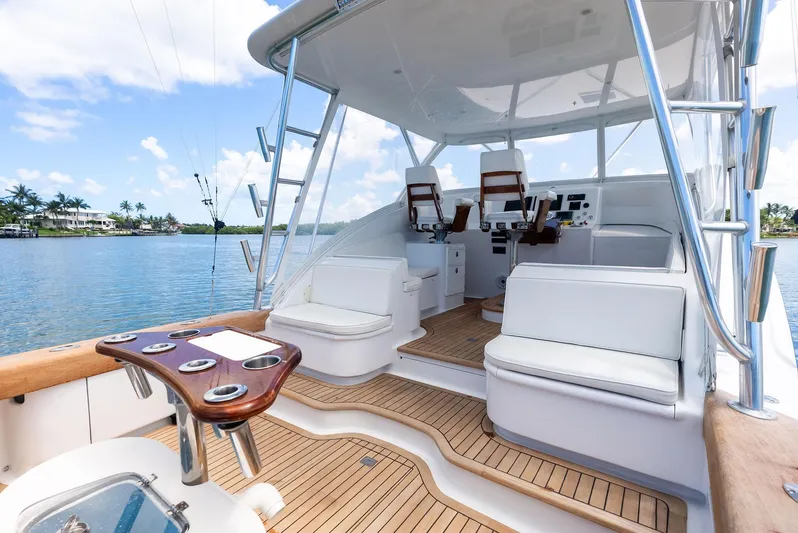 Let's Go Yacht Photos Pics 2018 Custom Carolina 35 Express yacht interior with seating and helm, docked by a scenic waterfront.