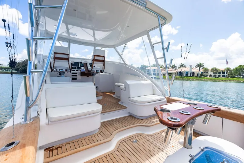 Let's Go Yacht Photos Pics 2018 Custom Carolina 35 Express yacht interior with seating, fishing rod holders, and scenic waterfront view.