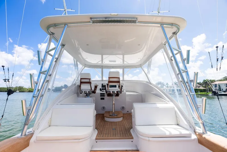 Let's Go Yacht Photos Pics 2018 Custom Carolina 35 Express boat interior with seating and helm, under clear blue sky.