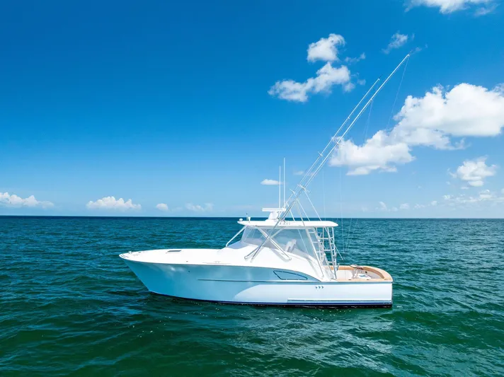 Let's Go Yacht Photos Pics 2018 Custom Carolina 35 Express yacht on open sea under clear blue sky.
