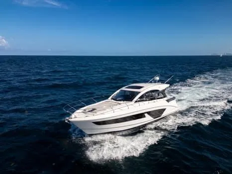 2023 Beneteau Gt45 Yacht Photos Pics 2023 Beneteau Gran Turismo 45 yacht cruising on open sea under clear blue sky.