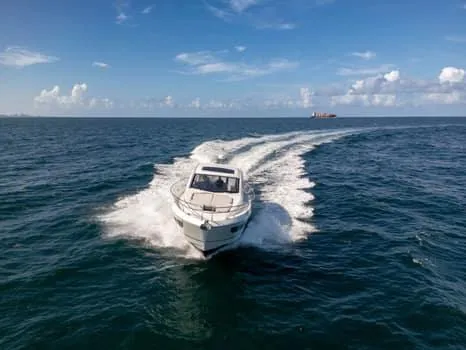 2023 Beneteau Gt45 Yacht Photos Pics 2023 Beneteau Gran Turismo 45 cruising on open sea under clear blue sky.