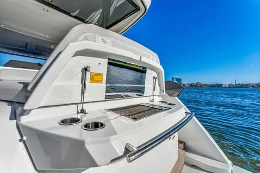 2023 Beneteau Gt45 Yacht Photos Pics 2023 Beneteau Gran Turismo 45 yacht with outdoor kitchen, overlooking serene blue waters.