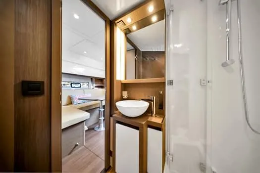 2023 Beneteau Gt45 Yacht Photos Pics Luxurious bathroom interior of 2023 Beneteau Gran Turismo 45 yacht, featuring modern fixtures.