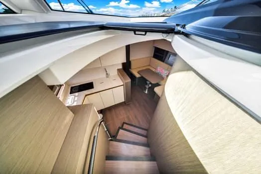 2023 Beneteau Gt45 Yacht Photos Pics Interior view of 2023 Beneteau Gran Turismo 45 yacht, featuring modern kitchen and seating area.