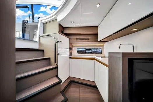 2023 Beneteau Gt45 Yacht Photos Pics Interior of 2023 Beneteau Gran Turismo 45 yacht, featuring modern kitchen and staircase.