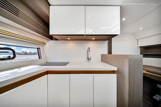 2023 Beneteau Gt45 Yacht Photos Pics Modern kitchen interior on 2023 Beneteau Gran Turismo 45 yacht, featuring sleek cabinetry and minimalist design.