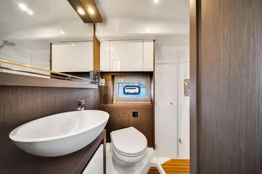 2023 Beneteau Gt45 Yacht Photos Pics Luxurious bathroom interior of 2023 Beneteau Gran Turismo 45 yacht, featuring modern fixtures and wood accents.