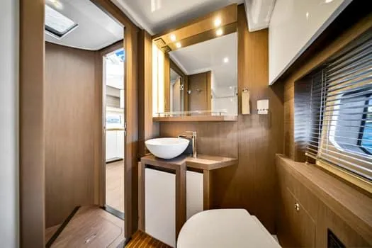 2023 Beneteau Gt45 Yacht Photos Pics Luxurious bathroom interior of 2023 Beneteau Gran Turismo 45 yacht, featuring modern fixtures and wood accents.