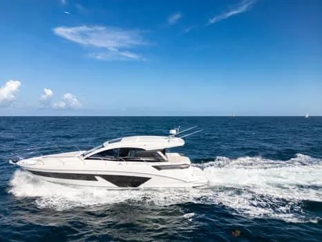 2023 Beneteau Gt45 Yacht Photos Pics 2023 Beneteau Gran Turismo 45 yacht cruising on open sea under clear blue sky.