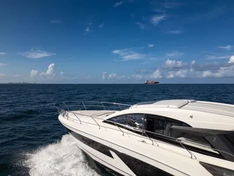 2023 Beneteau Gt45 Yacht Photos Pics 2023 Beneteau Gran Turismo 45 yacht cruising on open sea under clear blue sky.