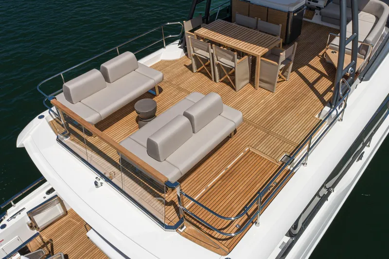  Yacht Photos Pics Luxurious 2024 Prestige X60 yacht deck with elegant seating and dining area.