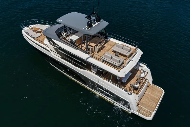  Yacht Photos Pics 2024 Prestige X60 luxury yacht cruising on open water, showcasing elegant design and spacious decks.