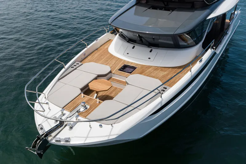  Yacht Photos Pics Luxurious 2024 Prestige X60 yacht with spacious deck and elegant design on calm waters.