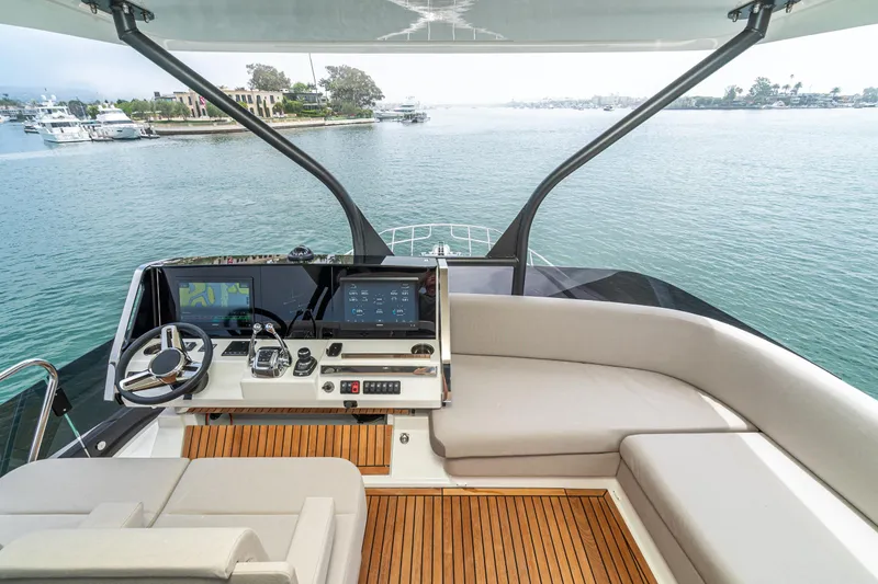  Yacht Photos Pics Luxurious 2024 Prestige X60 yacht helm with modern navigation system and elegant seating.