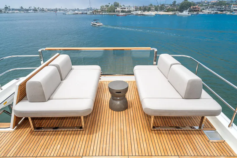  Yacht Photos Pics Luxurious 2024 Prestige X60 yacht deck with modern seating overlooking serene waters.